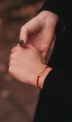 Red thread bracelet with infinity sign