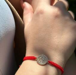 Red thread bracelet with tree of